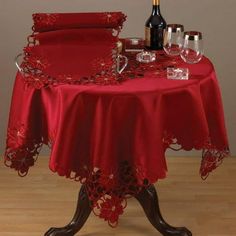 the table is covered with red cloths and wine glasses