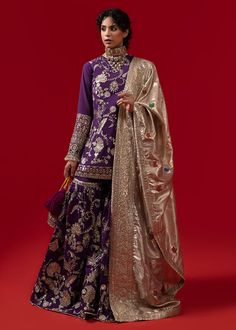 Buy Royal Pakistani Bridal Dress in Shirt and Gharara Style, a traditional masterpiece adorned with tilla work, embroidery, and sequin detail. Custom sizes Semi-stitched Banarasi Silk Sharara With Dabka Work, Wedding Palazzo Set With Dupatta In Jamawar, Wedding Jamawar Palazzo Set With Dupatta, Raw Silk Sharara With Resham Embroidery For Reception, Traditional Draped Lehenga With Mirror Work In Jamawar, Reception Sharara With Zari Work, Raw Silk Sharara With Zari Work For Reception, Chinon Sharara With Dabka Work For Reception, Wedding Sharara With Resham Embroidery In Dola Silk