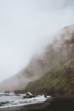 the beach is covered in fog and water