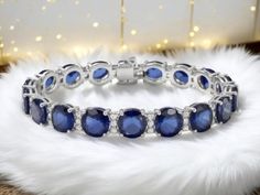 This exquisite tennis bracelet is a true testament to elegance and sophistication. Crafted from high-quality 925 sterling silver, it features genuine sapphires (lab grown) and sparkling cubic zirconia that enhance its beauty. Measuring approximately 18 cm in length, it comfortably fits most wrists, making it a perfect addition to any jewelry collection. And better yet this our sapphire ring comes in a hand sourced gift basket suited for royalty including a luxury silk scarf, a bath bomb, candle and soap. Sapphire Tennis Bracelet, Jewelry For Wedding, Luxury Silk Scarves, Xmas Gifts For Her, Wedding Jewelry Bracelets, Luxury Silk, Bath Bomb, Wedding Bracelet, Tennis Bracelet