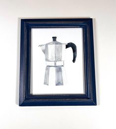 a coffee maker is framed in a blue frame on the wall next to a banana