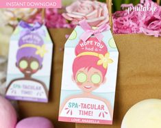 two tags with the words spa - tacular time on them and some flowers in the background