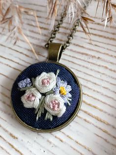 This hand embroidered pendant features a delicate floral design. The perfect accessory for you, or a great gift idea for a loved one. A beautiful and unique conversation piece. Each piece is unique. The design is set in an antique gold pendant and comes with either a 20 inch or 22 inch chain. Note that this is a handmade item. Actual colors may vary. Due to light and screen display the colours might be shown slightly different. *PLEASE NOTE* ITEM DETAILS - pendant measures 1" x1" - chain: 20" or Bohemian Jewelry With Floral Embroidery For Gifts, Embroidered Pendant Necklace For Gift, Antique Gold Pendant, Hand Embroidered Pendant, Embroidery Pendant, Hand Embroidered Necklace, Jewelry Embroidery, Hand Embroidered Jewelry, Embroidered Pendant