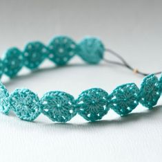 a crocheted headband made with blue yarn