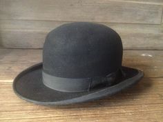 "Antique French Black Bowler Derby Hat Antique French black felted wool bowler derby hat. Leather headband with owners initials. Original black grosgrain ribbon bow and grosgrain ribbon edge. Measures; 21.5\" circumference, 4.5/5\" height, 2\" hat brim. Hat sized is marked as a 3 1/2, small size. Lovely antique condition, with fading and wear, no rips, tears or odors. Interior is clean. A bit dusty from years of storage...easy fix. There are crease marks showing at the top and the hat is somewha Vintage Formal Hat Bands, Classic Wool Hats For Derby, Vintage Formal Hat Bands In Solid Color, Formal Black Wool Felt Hat, Black Wool Felt Hat For Formal Occasions, Fitted Black Wool Hat Bands, Formal Black Wool Hat, Black Wool Top Hat With Short Brim, Classic Black Felt Hat For Formal Occasions