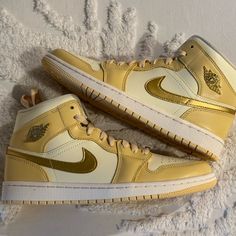 Wmns Air Jordan 1 Mid Se Pale Vanilla/Metallic Gold Vanille Pale/Or Metallique Gold Nike Shoes, Jordan Gold, Jordan 1 Low White, Wmns Air Jordan 1, Air Jordan 1 Mid Se, Jordan 12 Retro, Cute Nike Shoes, Womens Jordans, Girly Shoes