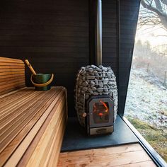 a wooden bench sitting next to a fire place