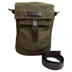 This GUCCI messenger bag is crafted of green canvas and brown cowhide leather featuring black chome toned hardware. Front flap buckle closure opens to a brown monogram jacquard interior with a zippered pocket. This messenger bag also features a front flap pocket with velcro closure. Made in Italy. Measures approximately 8.5 x 12 x 3 inches Strap drop 24 inches at its longest with 5-hole adjustment on each side (can punch additional holes if needed). Comes with dustbag and detachable leather strap. Condition - Fair vintage condition with some signs of wear Outside: Minor fading on canvas. Some cracks on leather trimmings and strap Inside: Minimal to no visible signs of wear Smell: No odor Gucci Shoulder Satchel, Gucci Shoulder Satchel For Everyday Use, Gucci Shoulder Bag For Everyday Use, Gucci Satchel For Everyday Use, Gucci Crossbody Shoulder Bag For Everyday Use, Brown Gucci Coated Canvas Shoulder Bag, Gucci Brown Coated Canvas Shoulder Bag, Gucci Flap Bag For Everyday Use, Gucci Flap Travel Bag