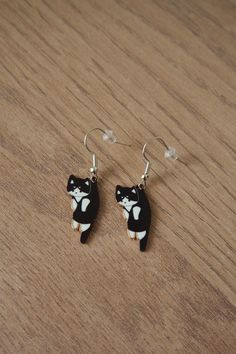 Black with white cat earrings  Cat charm pendants on steel hook ear wires Size is approximately: cats H 2.5cm x W 1cm, total drop of earrings 4cm This earrings can be a wonderful gift for someone you love, cat lovers gift, nice Christmas gift and stocking stuffer, cat owners gift idea This item is not suitable for children, keep away from kids Cute Cat Design Earrings For Gift, Cute Black Cat Earrings, Black Cat Design Drop Earrings, Novelty Black Cat Design Jewelry, Black Cat Earrings, Idea Birthday, Cat Charm, Christmas Gift Idea, Cat Jewelry