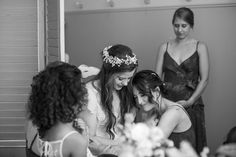 three women in dresses standing around each other