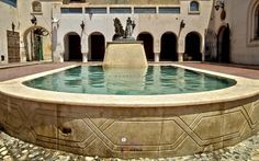 an outdoor fountain in the middle of a courtyard