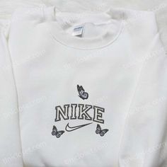 Nike x Butterflies Embroidered Sweatshirt, Animal Embroidered Shirt, The Best Gift Tinicloset is an ethereal haven nestled within the bustling tapestry of modern fashion, where each stitch, each delicate thread woven into the fabric, whispers tales of elegance and individuality. Our sanctum celebrates the artistry of personalized expression, specializing in bespoke embroidered apparel that transcends... White Custom Embroidered Sweatshirt For Spring, White Sweatshirt With Custom Embroidery For Spring, Spring White Sweatshirt With Custom Embroidery, White Cotton Tops With Butterfly Embroidery, Spring Streetwear Tops With Custom Embroidery, White Tops With Letter Embroidery For Spring, Casual White Top With Butterfly Embroidery, White Long Sleeve T-shirt With Floral Embroidery, White Embroidered Sweatshirt For Spring