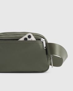 Here’s a unique way to bottle up waste. We transformed 4 plastic bottles into a super functional (and totally stylish) belt bag. Whether you're going for a walk, running errands, or attending a music festival, our Revive Nylon Belt Bag is the ideal accessory to keep your hands free and your belongings secure. Our premium, silky smooth nylon is ultra-durable, water-resistant, and lightweight, making it perfect for daily use.  | Quince | Women's Revive Nylon Belt Bag in Olive Functional Green Belt Bag For On-the-go, Functional Green Belt Bag With Adjustable Strap, Green Functional Belt Bag With Adjustable Strap, Functional Nylon Belt Bag For On-the-go, Functional Green Belt Bag With Removable Pouch, Green Nylon Belt Bag For Everyday Use, Modern Green Belt Bag For On-the-go, Versatile Green Belt Bag, Modern Belt Bag With Removable Pouch For Outdoor Activities