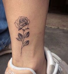 a small rose tattoo on the ankle