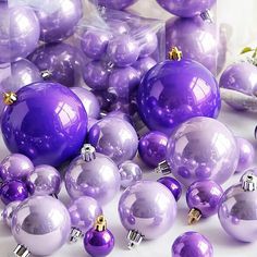 purple christmas ornaments are laying on the ground