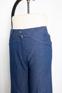 "Vintage 1970s dark wash denim light weight ankle length flared jeans. High waist, relaxed fit. Large belt loop flaps. No pockets. V seam rear. Orange top stitching. Zipper and snap button fly. Label: none Measurements: Waist: 28\" Hip: 36\" taken 7\" below the waist Length: 36.5\" Inseam: 25.5\" Rise: 11.5\" Condition: Excellent. Please do not hesitate to convo with any questions. We upload large pictures - Simply click on each picture for a closer look. More VINTAGE from DEJAVINTAGE here... ht Denim Blue Flare Jeans With Belt Loops, Retro Wide Leg Flare Jeans In Rigid Denim, Retro Medium Wash Bottoms With Standard Cut Leg, Vintage Dark Wash Bottoms With Hip Pockets, Retro Denim Jeans With Hip Pockets, Retro Denim Flare Jeans With Pockets, Retro Denim Blue Pants With Belt Loops, Vintage Medium Wash Bottoms With Hip Pockets, Retro Straight Leg Jeans With Hip Pockets