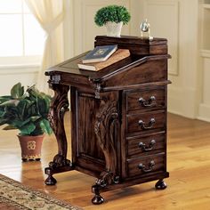 a wooden desk with drawers and a potted plant