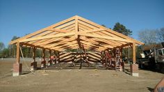 a large wooden structure is being built in the dirt