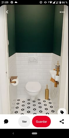 a white toilet sitting inside of a bathroom next to a sink and toilet paper dispenser