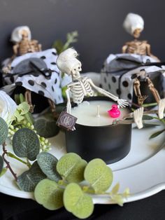 skeleton candles are sitting on a white plate