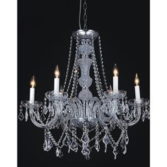 a crystal chandelier hanging from the ceiling with candles in front of black background