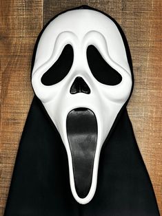 a black and white mask with an open mouth