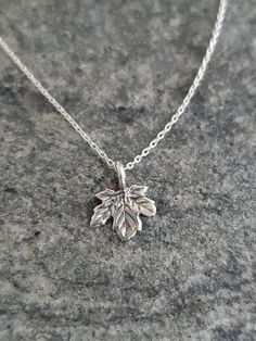 "Tiny sterling silver leaf. This tiny pendant measures 9mm across and is made of solid sterling silver. It hangs from a delicate sterling chain and has a shiny finish with a slightly antiqued look to give the grains in the leaf more texture. Sweet and delicate everyday necklace! Shown here in 16\" length. *If you are unsure of the length you need, or would like to wear this item at different lengths, we now offer an adjustable length option! You can add an adjustable end to your necklace using t Minimalist Leaf-shaped Sterling Silver Jewelry, Minimalist Sterling Silver Leaf Jewelry, Tiny Sterling Silver Necklace In Silver, Everyday Sterling Silver Leaf Jewelry, Silver Leaf-shaped Necklaces For Gift, Silver Leaf-shaped Necklace Gift, Silver Leaf-shaped Necklace For Gift, Sterling Silver Leaf-shaped Jewelry Gift, Sterling Silver Leaf-shaped Jewelry