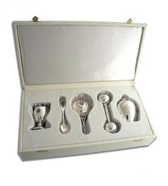 an open box with five spoons in it