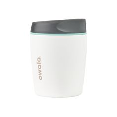 a white and grey coffee cup with the word ovo on it's side