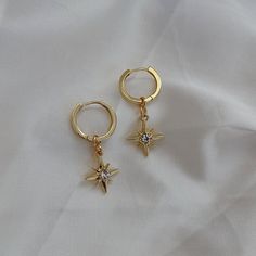 🖊️ Product details 🖊️ Handmade 18K Gold Plated Brass huggie earrings. Suitable for sensitive ears. Star charm: 12mm Huggie: 1.4cm in diameter Earring pin: 1mm 🫶 Product care 🫶 - To avoid your jewellery tarnishing from moisture and liquids, please refrain from wearing then in places such as pools and during intense exercise. - Keep your jewellery protected from the sun and safe from scratches and chips. It's best if you store your jewellery in air tight space. - Our jewellery are handmade with love, so please handle them carefully 😊 💌 Handling 💌 Please allow for 1-2 business days for your pieces to be made and packaged with care. Your order will be shipped in a padded envelope to ensure that your jewellery arrives safely. 💛 Thank you for choosing our store, we hope you love your goo 14k Gold Filled Earrings With Star Charm As Gift, Elegant Hypoallergenic Star Hoop Earrings, Elegant Gold Hoop Earrings With Star Charm, Elegant Round Hoop Earrings With Star Charm, 14k Gold Celestial Hoop Earrings, Anniversary Yellow Gold Star Charm Earrings, Anniversary Yellow Gold Earrings With Star Charm, Gold-plated Hoop Earrings With Star Charm, Celestial Huggie Pierced Earrings