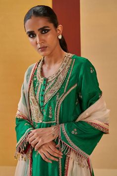 Green A-line kurta with zardozi, sequin, gota embroidered yoke in geometric pattern. Paired with pant and ivory dupatta.
Components: 3
Pattern: Embroidery
Type Of Work: Zardozi, sequin, gota, geometric
Neckline: Round
Sleeve Type: Bell sleeves
Fabric: Silk Organza
Color: Green
Other Details: 
Contrast sheer dupatta
Front embellished buttons
Tassel fringe border
Embroidery on pan hem
Occasion: Sangeet - Aza Fashions Dola Silk Kurta With Mirror Work For Reception, Traditional Straight Kurta With Mirror Work For Reception, Reception Dola Silk Kurta With Mirror Work, Eid Reception Traditional Wear With Gota Work, Zari Work Straight Kurta Palazzo Set For Reception, Straight Kurta Palazzo Set With Zari Work For Reception, Festive Palazzo Set With Dabka Work For Reception, Bollywood Style Kurta With Mirror Work For Reception, Festive Semi-stitched Kurta For Reception