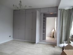 an empty room with closets and a chandelier hanging from the light fixture