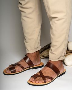 Timeless and classic, Greek leather sandals for men offer both comfort and durability. Handmade with high-quality leather from Crete, they are a must-have for any fashion-conscious man. Suitable for any occasion, their simple yet elegant design complements both casual and formal attire. Natural irregularities in color and texture add to their charm. SIZE GUIDE All genuine leather sandals can be stiff at the begging and widen after few days of wearing them.  If you wear a half size, choose the ne Leather Sandals For Men, Minimalist Sandals, Conscious Man, Brown Shoes Men, Toe Ring Sandals, Mens Shoes Sandals, Mens Leather Sandals, Genuine Leather Sandals, Greek Sandals