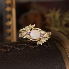 Opal ring with amethyst and gold leaf designs, part of the Rose Blossom collection. Whimsigoth Engagement Ring, Floral Wedding Ring, Halloween Ring, Rose Blossom, October Birthstone Rings, Three Stone Rings, Opal Ring, Engagement Ring Wedding Band, Mens Wedding Rings