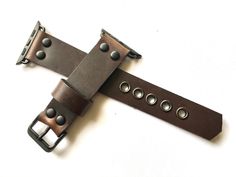 This is my latest design of Horween Dark Brown Chromexcel leather strap.  This Dark Blue leather strap is made from high quality full grain leather.  The entire process is done by hand, no machines involved This band is designed for heavy duty use and sports, it has strong eyelets used to support the punch holes so it will be durable in years to come. The width and length vary. Please select the width of the strap and the length (wrist size) in the "variations" field. For any further customizati Adjustable Brown Watch With Black Band, Adjustable Leather Watch Bands With Black Band, Adjustable Leather Watch Band In Black, Brown Leather Watch Band With Adjustable Strap, Adjustable Black Leather Watch Band, Brown Leather Bracelet With Black Band, Adjustable Distressed Brown Leather Watch Bands, Adjustable Leather Watch Band With Waxed Finish, Vintage Brown Leather Apple Watch Band