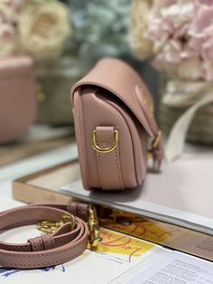 Luxury Everyday Saddle Bag With Adjustable Strap, Luxury Everyday Shoulder Flap Bag, Luxury Everyday Crossbody Saddle Bag, Luxury Crossbody Saddle Bag For Everyday, Luxury Everyday Baguette Bag With Adjustable Strap, High-end Everyday Luxury Satchel Shoulder Bag, Luxury Pink Pouch Satchel, Luxury Pink Pouch-shaped Satchel, Luxury Canvas Shoulder Bag For Daily Use