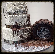 a three tiered cake with chocolate frosting on top