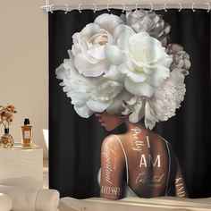 there is a shower curtain with flowers in the hair and on the back of it