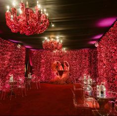 a red carpeted room with chandeliers and tables set up for an event