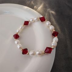 Pearls are known for their roundness, fullness and warm color, adding a touch of gentleness and nobility to the wearer. Red crystals are carefully cut to create square facets that sparkle in the sunlight or light. Red crystals not only symbolize passion and vitality, but also happiness and good fortune, bringing positive energy to the wearer. Red crystal bead measure approx. 8mm big, and freshwater pearls measure approx. 6mm big. Each natural freshwater pearl is unique, their size and shape migh Elegant Red Crystal Bracelet As Gift, Elegant Red Round Bead Bracelets, Handmade Elegant Red Crystal Bracelet, Elegant Red Beaded Bracelets For Valentine's Day, Elegant Red Round Beaded Bracelets, Elegant Handmade Red Crystal Bracelet, Elegant Red Beaded Pearl Bracelet, Elegant Red Beaded Bangle Bracelet, Elegant Red Round Crystal Bracelet