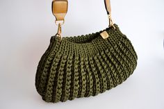 a green purse is hanging on the wall