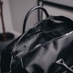 Designed to be minimal and understated, we've made a bag perfect for everyday use. Our minimalist holdall has an outer zip pocket, a grab handle, three inside pockets, and a leather shoulder strap, as well as a magnetic slot for easy access to your belongings. 47cm x 22cm x 27cm (can be used as carry-on luggage). Water-resistant. 28-litre capacity. Includes detachable shoulder strap. Outer zip pocket perfect for accessories. Two open inside pockets and one inside zipped pocket. Made from vegan l Modern Weekender Bag With Leather Handles For On-the-go, On-the-go Satchel Briefcase With Zipper Pocket, Functional Everyday Bag With Zipper Closure, Functional Everyday Bags With Zipper Closure, Versatile Briefcase With Zipper Closure For On-the-go, Minimalist Bag With Double Top Carry Handle, Minimalist Bag With Double Top Handles, Modern Laptop Bag With Zipper And Top Handle, Modern Travel Bag With Adjustable Strap And Top Handle