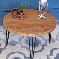 a wooden table with hairpin legs and a potted plant sitting on top of it