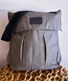 a gray bag sitting on top of a table