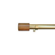 a brass and wood curtain rod on a white background