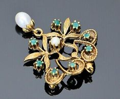 "This is a 14K Yellow Gold Floral Emerald & Pearl set Brooch, 8 Emeralds & Pearl Prong set with Pearl Suspension, 1.5\" height, Circa 1950, weight 6.8 grams Stock # BB95L09 This listing contains photographs of the actual item you will receive. Our items are in excellent condition with little or no signs of wear and many are one of a kind pre-owned estate finds. Please look closely at the pictures in this listing as they are part of the product description. Please read the description, as Traditional Yellow Gold Brooches For Formal Occasions, Traditional Yellow Gold Formal Brooches, Traditional Yellow Gold Pendant Brooches, Traditional Hallmarked Brooch For Formal Occasions, Formal Filigree Pendant Brooch, Ornate Yellow Gold Brooch For Formal Occasions, Formal Pendant Brooch With Intricate Design, Traditional Evening Jewelry Brooch, Traditional Evening Brooch Jewelry