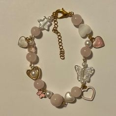 This charm bracelet has 4 charms and is made up of rose quartz beads! Every order comes with extras. Cute Clay Jewelry, Elle Graham, Ropa Y2k, Birthdays Presents, Aesthetic Bracelet, Girly Bracelets, Diy Charm Bracelet, Diy Bracelet Designs, Beads Bracelet Design