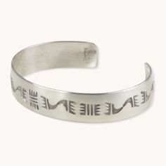 The Stamp Dancer: Bears Journey Cuff Bracelet is crafted with sterling silver, giving it a durable and luxurious finish. This bracelet cuff is intricately detailed with a southwestern stamp pattern, making it the perfect accessory for any jewelry collection. The Bear’s Journey cuff bracelet was created by artist Marion Lovato of Kewa Pueblo. Sterling Silver Hand-Stamped Cuff Bracelet 1/2" Width Rustic Patina Finish Western Turquoise Stamped Cuff Bracelet, Luxury Southwestern Stamped Cuff Bracelet, Southwestern Stamped Cuff Jewelry, Vintage Turquoise Stamped Cuff Bracelet, Southwestern Silver Engraved Cuff Bracelet, Stamp Pattern, Hand Stamped Cuff Bracelet, Patina Finish, Bracelet Cuff