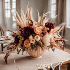 a vase filled with flowers on top of a table