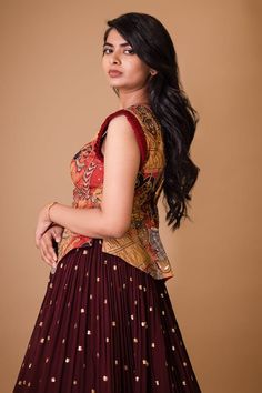 Maroon attached cancan lehenga with hand painted kalamkari border and embroidered glass beads. Paired with a padded peplum blouse with cream ajantha work, glass beads embroidery and pleat detailing on sleeves. - Aza Fashions Traditional Sleeveless Lehenga For Eid, Sleeveless Art Silk Dress For Diwali, Traditional Sleeveless Cutdana Dress, Sleeveless Chinon Dresses For Eid, Unstitched Sleeveless Traditional Sets, Traditional Sleeveless Set With Zari Work, Navratri Sleeveless Art Silk Dresses, Traditional Sleeveless Lehenga With Pallu, Sleeveless Anarkali Style Pre-draped Saree In Georgette